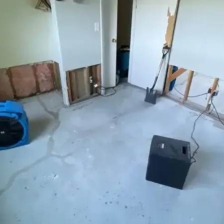 Commercial dehumidifiers and air movers drying an open shop floor