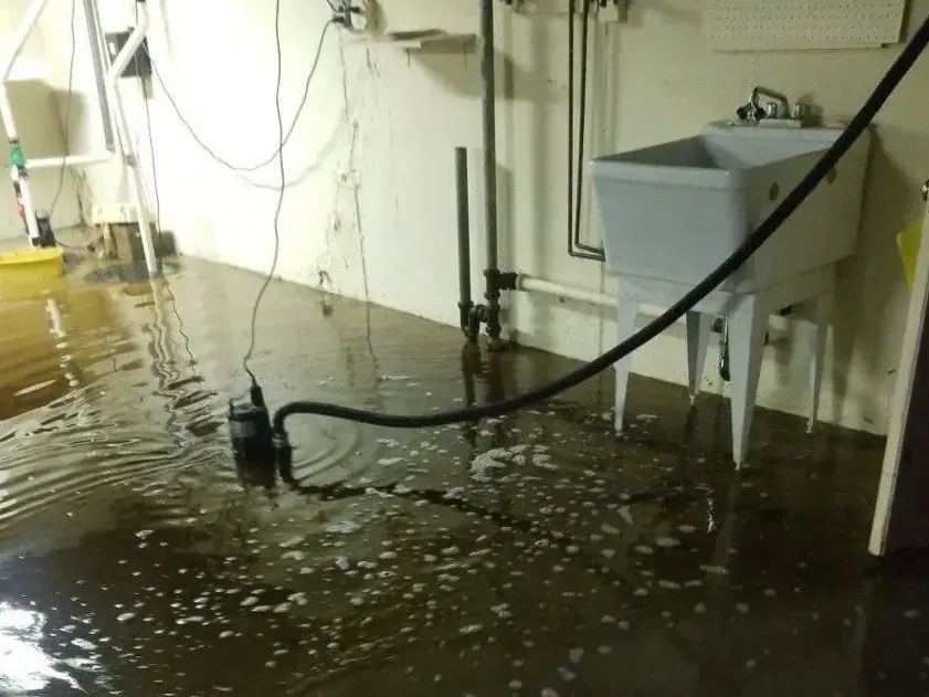 Sump pit and pump in a basement after groundwater backed up