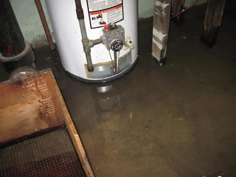 Water pooled around a failed water heater in a utility space